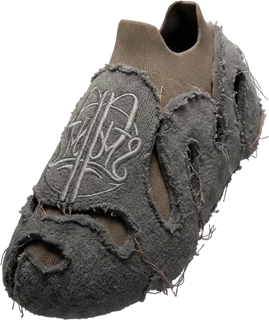 A single grey slip-on shoe with a fuzzy outer layer, cut-outs and a light logo on top, seen at an angle.